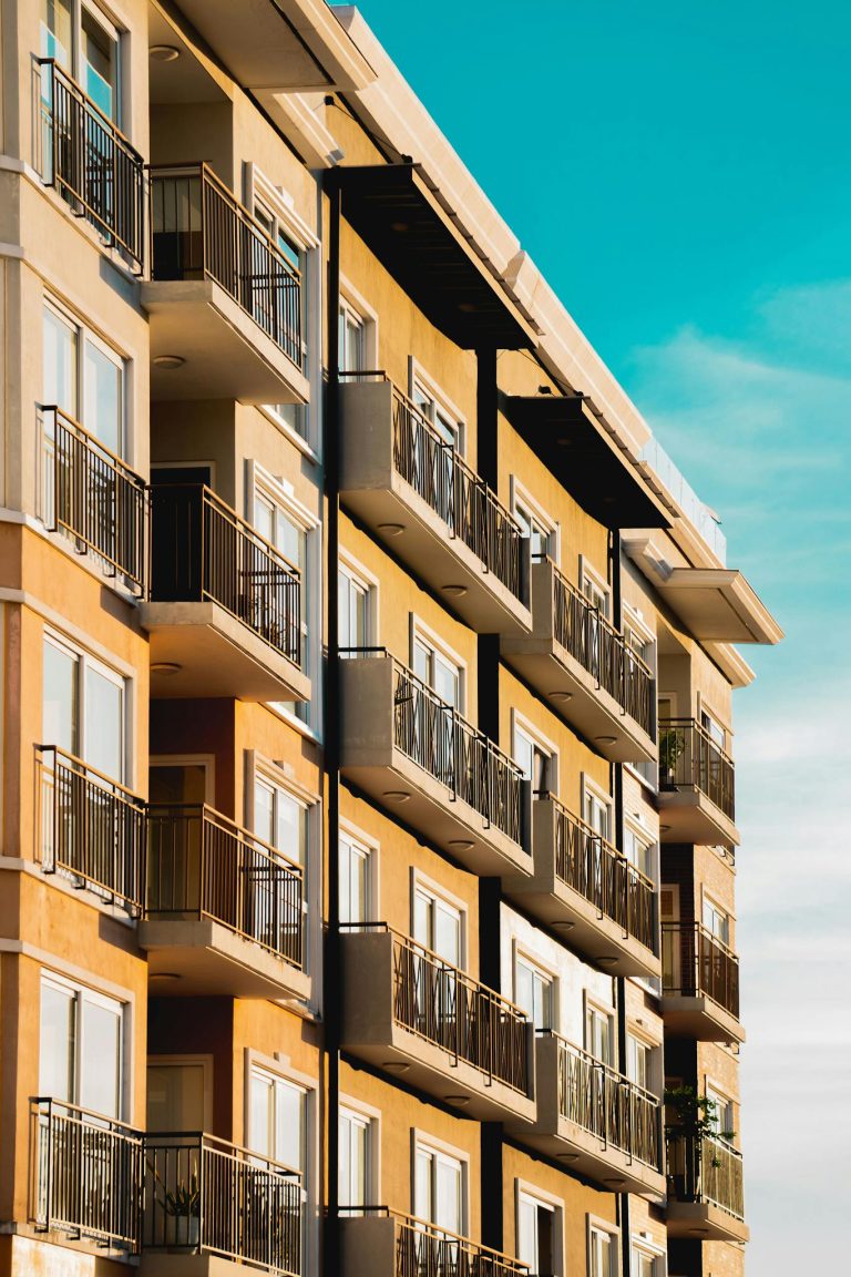 Contemporary apartment building with multiple balconies, capturing urban architectural style.